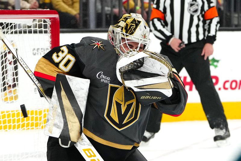 Dec 10, 2023; Las Vegas, Nevada, USA; Vegas Golden Knights goaltender Jiri Patera (30) makes a save against the San Jose Sharks during the first period at T-Mobile Arena. Mandatory Credit: Stephen R. Sylvanie-USA TODAY Sports