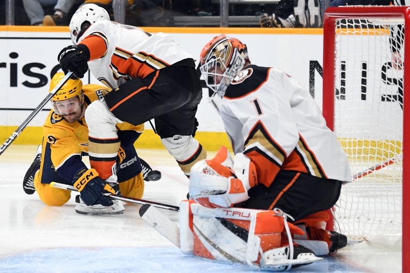 Jan 9, 2024; Nashville, Tennessee, USA; Nashville Predators left wing Filip Forsberg (9) attempts a wrap around shot from his knees against Anaheim Ducks goaltender Lukas Dostal (1) during the third period at Bridgestone Arena. Mandatory Credit: Christopher Hanewinckel-USA TODAY Sports