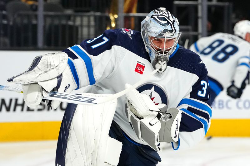 Nov 2, 2023; Las Vegas, Nevada, USA; Winnipeg Jets goaltender Connor Hellebuyck (37) warms up before a game against the Vegas Golden Knights at T-Mobile Arena. Mandatory Credit: Stephen R. Sylvanie-USA TODAY Sports