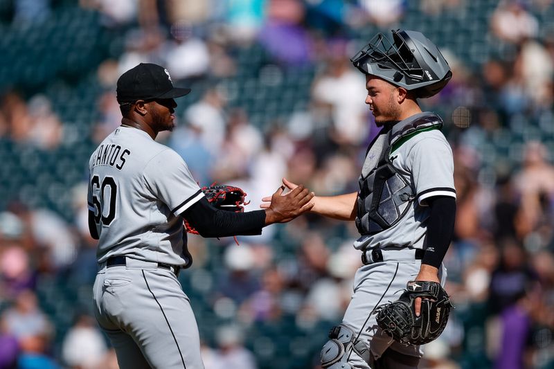 Aug 20, 2023; Denver, Colorado, USA; Chicago White Sox relief pitcher Gregory Santos (60) reacts with catcher Yasmani Grandal (24) after the game against the Colorado Rockies at Coors Field. Mandatory Credit: Isaiah J. Downing-USA TODAY Sports