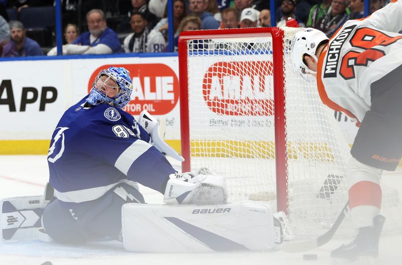 Mar 17, 2025; Tampa, Florida, USA; Tampa Bay Lightning goaltender Andrei Vasilevskiy (88) makes a save from Philadelphia Flyers right wing Matvei Michkov (39) during the second period at Amalie Arena. Mandatory Credit: Kim Klement Neitzel-Imagn Images