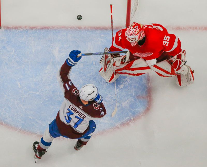 Mar 18, 2023; Detroit, Michigan, USA; Colorado Avalanche center J.T. Compher (37) raises his stick in celebration as the puck passes Detroit Red Wings goaltender Ville Husso (35) during the second period at Little Caesars Arena. Mandatory Credit: Brian Bradshaw Sevald-USA TODAY Sports