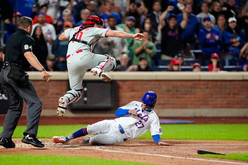 Sep 22, 2024; New York City, New York, USA;  New York Mets third baseman Mark Vientos (27) slides safely into home plate ahead of the throw to Philadelphia Phillies catcher J.T. Realmuto (10) on New York Mets center fielder Tyrone Taylor (not pictured) RBI single during the second inning at Citi Field. Mandatory Credit: Gregory Fisher-Imagn Images