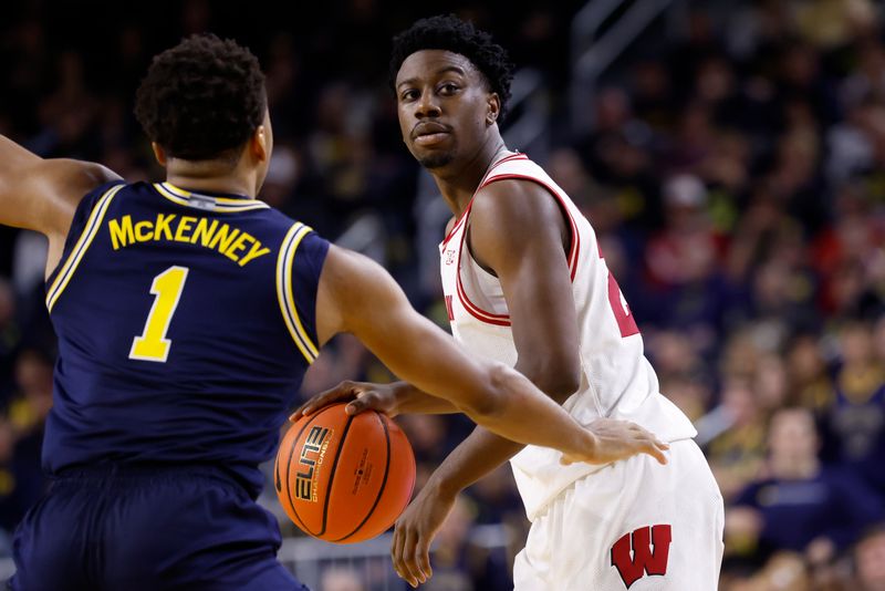 Jan 10, 2026; Ann Arbor, Michigan, USA;  Wisconsin Badgers guard John Blackwell (25) is defended by Michigan Wolverines guard Trey McKenney (1) in the second half at Crisler Center. Mandatory Credit: Rick Osentoski-Imagn Images