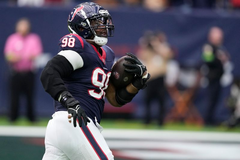 Houston Texans defensive tackle Sheldon Rankins (98) runs to the end zone for a touchdown after recovering a Tennessee Titans fumble during the first half of an NFL football game Sunday, Dec. 31, 2023, in Houston. (AP Photo/David J. Phillip)