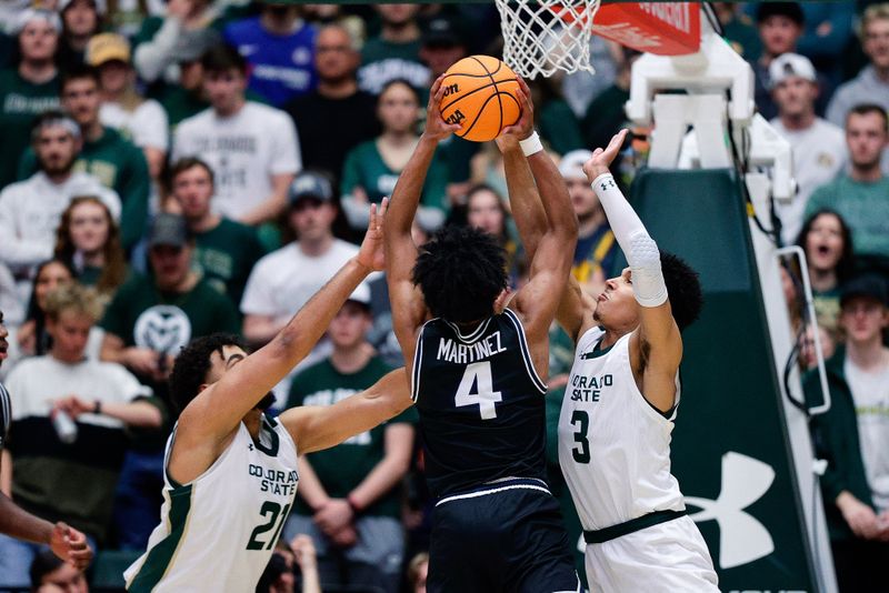 Feb 17, 2024; Fort Collins, Colorado, USA; Utah State Aggies guard Ian Martinez (4) drives to the net against Colorado State Rams guard Rashaan Mbemba (21) and guard Josiah Strong (3) in the second half at Moby Arena. Mandatory Credit: Isaiah J. Downing-USA TODAY Sports