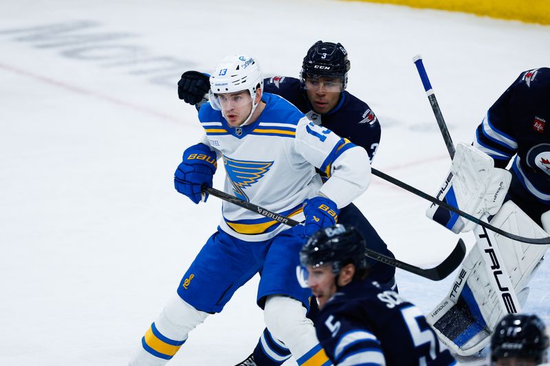 Jan 20, 2026; Winnipeg, Manitoba, CAN; Winnipeg Jets defenseman Isaak Phillips (3) jostles for position with St. Louis Blues forward Alexey Toropchenko (13) during the third period at Canada Life Centre. Mandatory Credit: Terrence Lee-Imagn Images