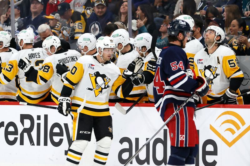 Oct 20, 2024; Winnipeg, Manitoba, CAN; Pittsburgh Penguins center Lars Eller (20) celebrates his second period goal against the Winnipeg Jets at Canada Life Centre. Mandatory Credit: James Carey Lauder-Imagn Images