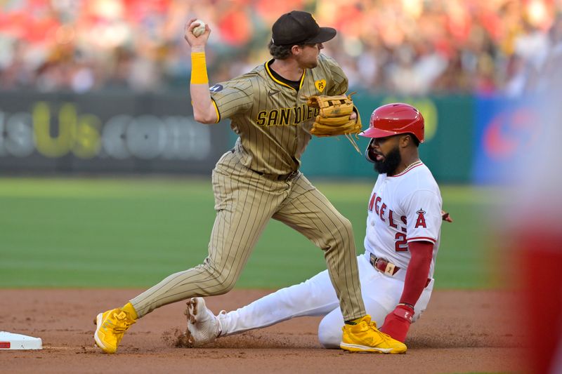 Jun 4, 2024; Anaheim, California, USA;  San Diego Padres first baseman Jake Cronenworth (9) throws to first as Los Angeles Angels second baseman Luis Rengifo (2) is out on a double play in the first inning at Angel Stadium. Mandatory Credit: Jayne Kamin-Oncea-USA TODAY Sports