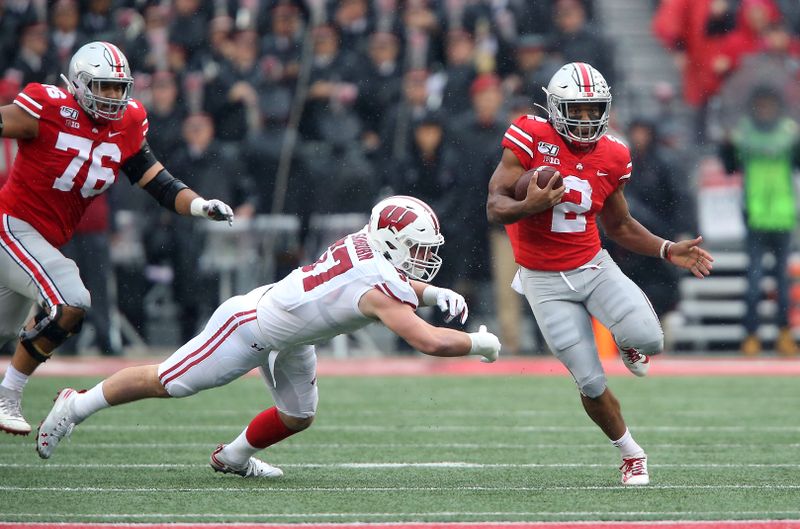 Oct 26, 2019; Columbus, OH, USA; Ohio State Buckeyes running back J.K. Dobbins (2) runs past Wisconsin Badgers linebacker Jack Sanborn (57)during the first quarter at Ohio Stadium. Mandatory Credit: Joe Maiorana-USA TODAY Sports