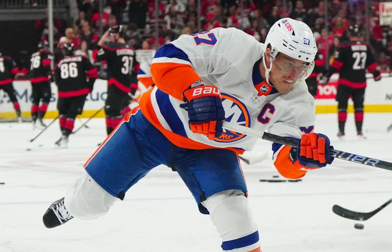 Apr 30, 2024; Raleigh, North Carolina, USA; New York Islanders left wing Anders Lee (27) takes a shot during the warmups before the game aCarolina Hurricanes in game five of the first round of the 2024 Stanley Cup Playoffs at PNC Arena. Mandatory Credit: James Guillory-USA TODAY Sports