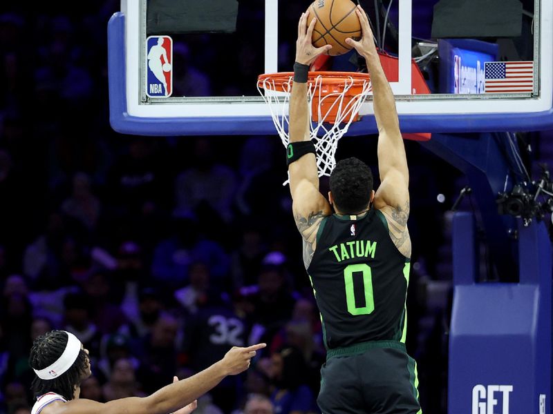 PHILADELPHIA, PENNSYLVANIA - FEBRUARY 02: Jayson Tatum #0 of the Boston Celtics dunks the ball as Ricky Council IV #14 of the Philadelphia 76ers reacts during the first half at the Wells Fargo Center on February 02, 2025 in Philadelphia, Pennsylvania. NOTE TO USER: User expressly acknowledges and agrees that, by downloading and or using this photograph, User is consenting to the terms and conditions of the Getty Images License Agreement. (Photo by Emilee Chinn/Getty Images)