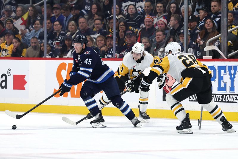 Nov 1, 2025; Winnipeg, Manitoba, CAN;Winnipeg Jets left wing Cole Koepke (45) skates away from Pittsburgh Penguins right wing Ville Koivunen (41) and Pittsburgh Penguins defenseman Parker Wotherspoon (28) in the second period at Canada Life Centre. Mandatory Credit: James Carey Lauder-Imagn Images