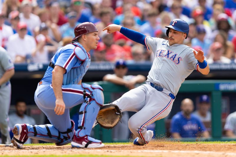 May 23, 2024; Philadelphia, Pennsylvania, USA; Texas Rangers first base Nathaniel Lowe (30) scores past Philadelphia Phillies catcher J.T. Realmuto (10) at Citizens Bank Park. Mandatory Credit: Bill Streicher-USA TODAY Sports