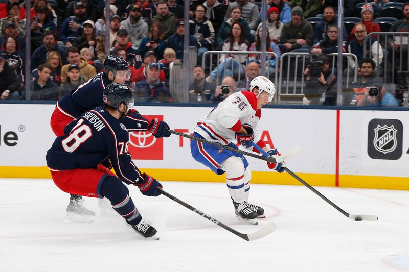 Nov 17, 2025; Columbus, Ohio, USA; Montreal Canadiens center Zack Bolduc (76) looks to shoot as Columbus Blue Jackets defenseman Damon Severson (78) trails the play during the first period at Nationwide Arena. Mandatory Credit: Russell LaBounty-Imagn Images