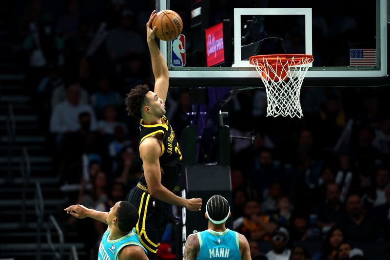 CHARLOTTE, NORTH CAROLINA - MARCH 29: Trayce Jackson-Davis #32 of the Golden State Warriors dunks the ball during the second half of the game against the Charlotte Hornets at Spectrum Center on March 29, 2024 in Charlotte, North Carolina. NOTE TO USER: User expressly acknowledges and agrees that, by downloading and or using this photograph, User is consenting to the terms and conditions of the Getty Images License Agreement. (Photo by Jared C. Tilton/Getty Images)