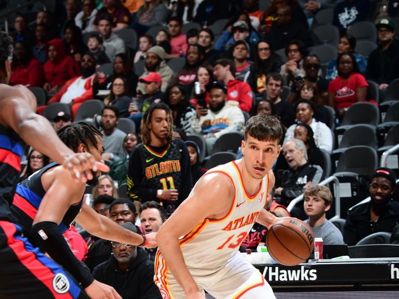 ATLANTA, GA - APRIL 3: Bogdan Bogdanovic #13 of the Atlanta Hawks dribbles the ball during the game against the Detroit Pistons on April 3, 2024 at State Farm Arena in Atlanta, Georgia.  NOTE TO USER: User expressly acknowledges and agrees that, by downloading and/or using this Photograph, user is consenting to the terms and conditions of the Getty Images License Agreement. Mandatory Copyright Notice: Copyright 2024 NBAE (Photo by Scott Cunningham/NBAE via Getty Images)