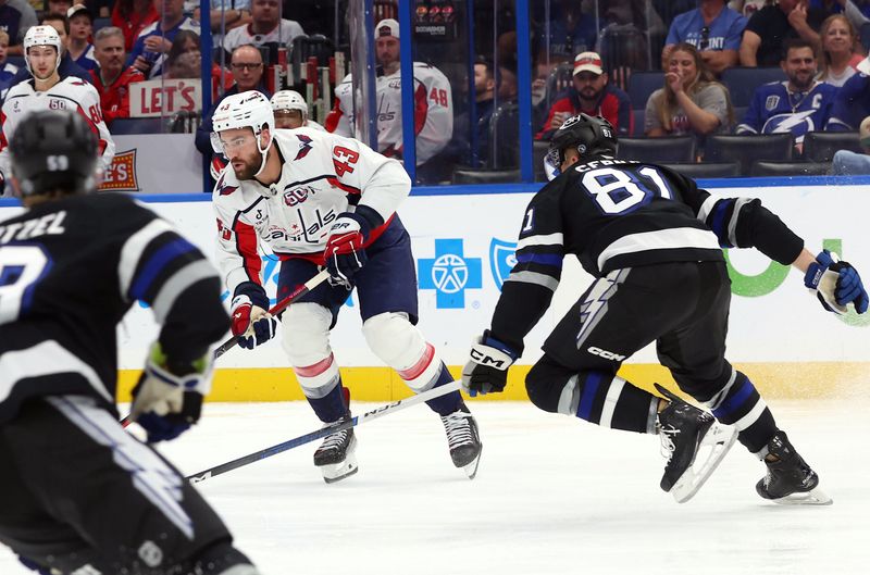 Oct 26, 2024; Tampa, Florida, USA; Washington Capitals right wing Tom Wilson (43) skates with the puck as Tampa Bay Lightning defenseman Erik Cernak (81) defends during the second period at Amalie Arena. Mandatory Credit: Kim Klement Neitzel-Imagn Images