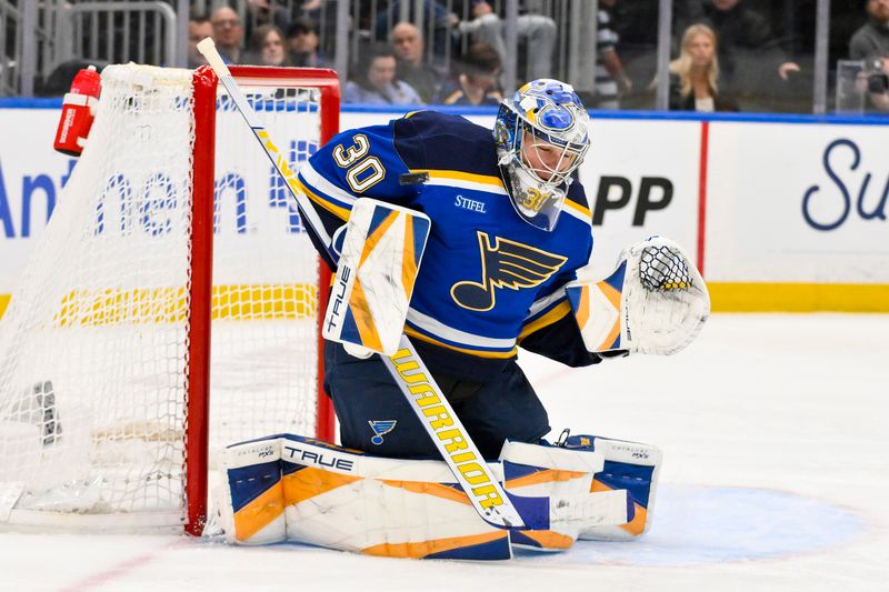 Apr 3, 2025; St. Louis, Missouri, USA;  St. Louis Blues goaltender Joel Hofer (30) defends the net against the Pittsburgh Penguins during the third period at Enterprise Center. Mandatory Credit: Jeff Curry-Imagn Images