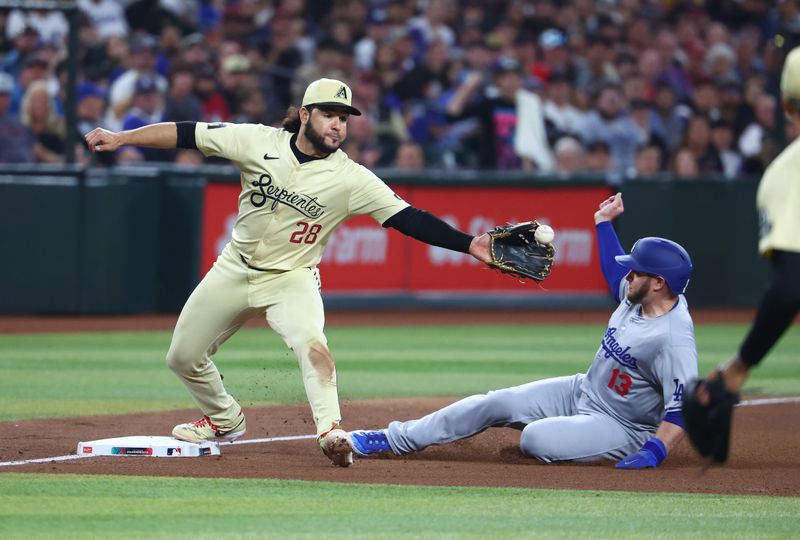 Apr 30, 2024; Phoenix, Arizona, USA; Arizona Diamondbacks third baseman Eugenio Suarez (28) forces out sliding Los Angeles Dodgers base runner Max Muncy in the fifth inning at Chase Field. Mandatory Credit: Mark J. Rebilas-USA TODAY Sports