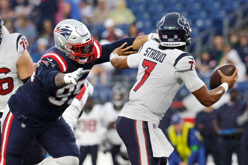 New England Patriots defensive tackle Daniel Ekuale, left, chases down Houston Texans quarterback C.J. Stroud (7) during the first half of an NFL preseason football game Thursday, Aug. 10, 2023, in Foxborough, Mass. (AP Photo/Michael Dwyer)