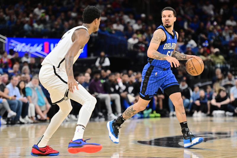 ORLANDO, FLORIDA - FEBRUARY 27: Cole Anthony #50 of the Orlando Magic dribbles the ball against Nic Claxton #33 of the Brooklyn Nets in the first half of a game at Kia Center on February 27, 2024 in Orlando, Florida. NOTE TO USER: User expressly acknowledges and agrees that, by downloading and or using this photograph, User is consenting to the terms and conditions of the Getty Images License Agreement. (Photo by Julio Aguilar/Getty Images)