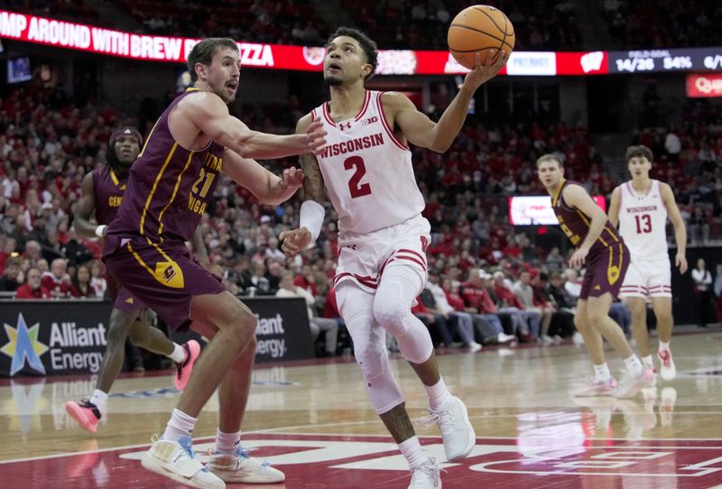 Dec 22, 2025; Madison, Wisconsin, USA; Wisconsin guard Nick Boyd (2) drives on Central Michigan forward Nick Mullen (21) during the second half of their game at the Kohl Center. Wisconsin beat Central Michigan 88-61. Mandatory Credit: Mark Hoffman-USA TODAY Network via Imagn Images