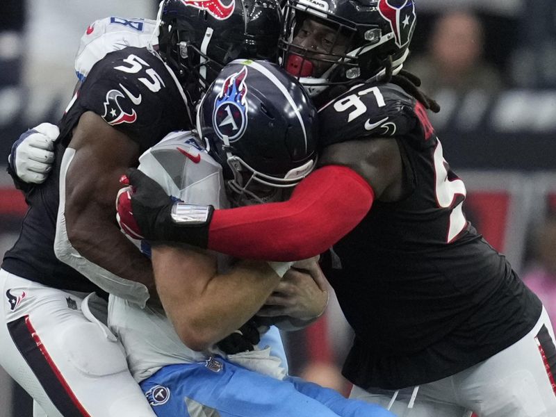 Houston Texans defensive end Danielle Hunter (55) and defensive tackle Mario Edwards Jr. (97) sack Tennessee Titans quarterback Will Levis, center, during the first half of an NFL football game Sunday, Nov. 24, 2024, in Houston. (AP Photo/Ashley Landis)