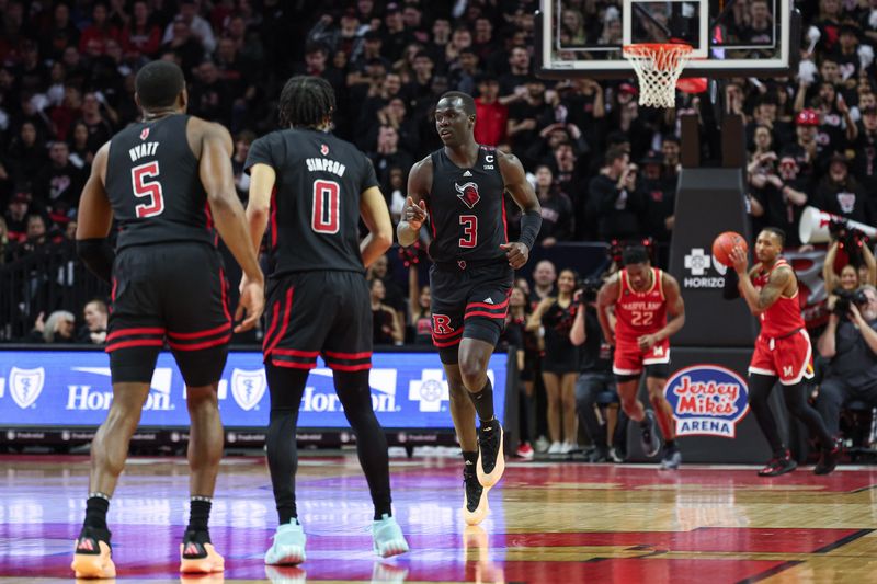 Feb 25, 2024; Piscataway, New Jersey, USA; Rutgers Scarlet Knights forward Mawot Mag (3) reacts after a basket with forward Aundre Hyatt (5) and guard Derek Simpson (0) during the first half against the Maryland Terrapins at Jersey Mike's Arena. Mandatory Credit: Vincent Carchietta-USA TODAY Sports