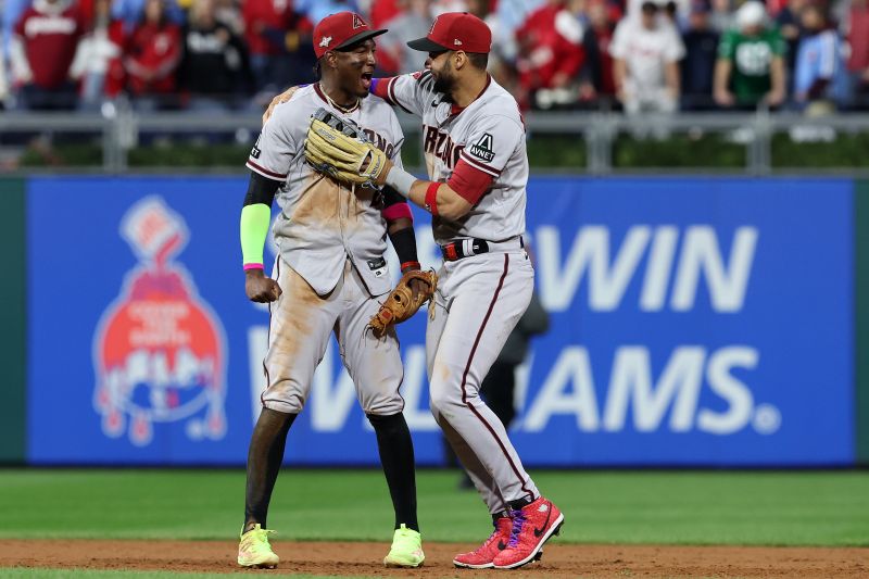 Oct 24, 2023; Philadelphia, Pennsylvania, USA; Arizona Diamondbacks left fielder Lourdes Gurriel Jr. (12) and  shortstop Geraldo Perdomo (2) react after defeating the Philadelphia Phillies in game seven of the NLCS for the 2023 MLB playoffs at Citizens Bank Park. Mandatory Credit: Bill Streicher-USA TODAY Sports