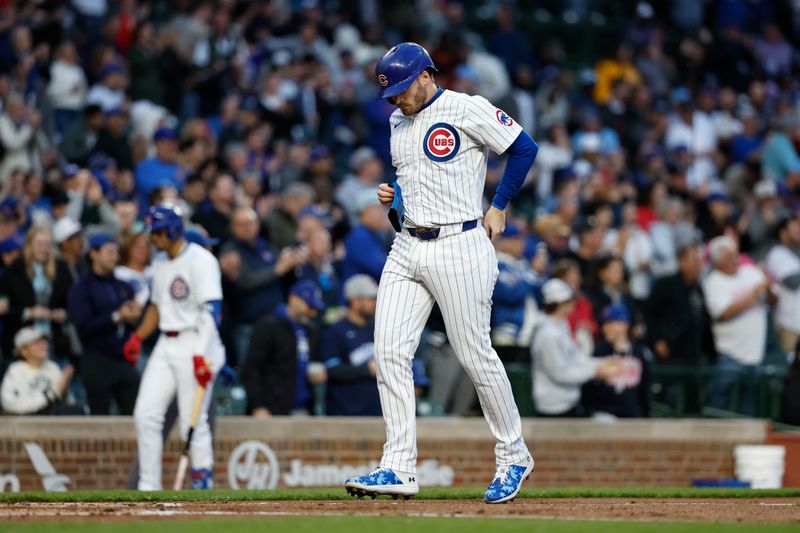 Apr 23, 2024; Chicago, Illinois, USA; Chicago Cubs outfielder Ian Happ (8) scores against the Houston Astros during the first inning at Wrigley Field. Mandatory Credit: Kamil Krzaczynski-USA TODAY Sports