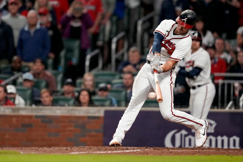 Oct 12, 2022; Atlanta, Georgia, USA; Atlanta Braves first baseman Matt Olson (28) hits an RBI single against the Philadelphia Phillies in the sixth inning during game two of the NLDS for the 2022 MLB Playoffs at Truist Park. Mandatory Credit: Dale Zanine-USA TODAY Sports