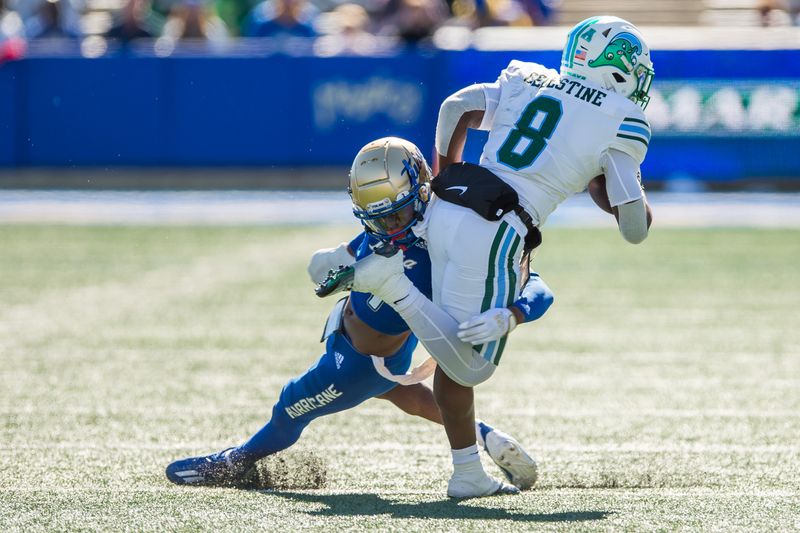 Nov 5, 2022; Tulsa, Oklahoma, USA;  Tulsa Golden Hurricane cornerback Tyree Carlisle (4) attempts to tackle Tulane Green Wave running back Iverson Celestine (8) during the third quarter at Skelly Field at H.A. Chapman Stadium. Tulane won 27-13. Mandatory Credit: Brett Rojo-USA TODAY Sports