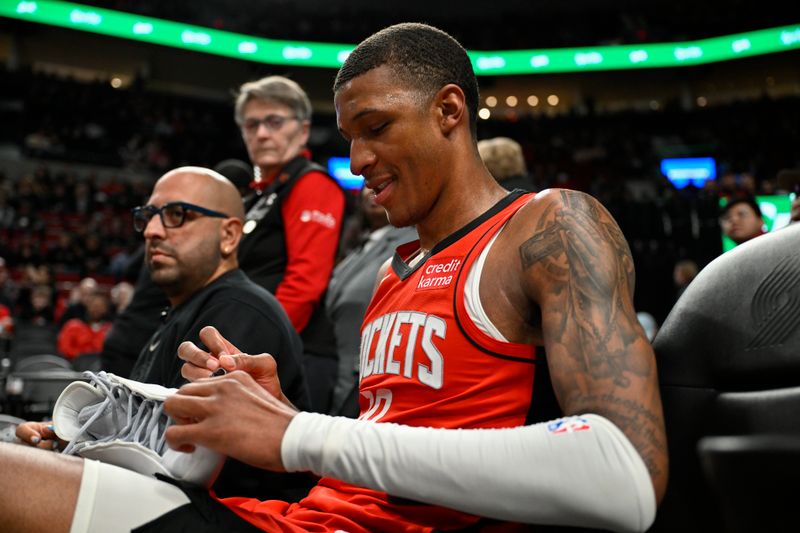 PORTLAND, OREGON - MARCH 08: Jabari Smith Jr. #10 of the Houston Rockets signs his shoes during the fourth quarter of the game against the Portland Trail Blazers at the Moda Center on March 08, 2024 in Portland, Oregon. The Houston Rockets won 123-107. NOTE TO USER: User expressly acknowledges and agrees that, by downloading and or using this photograph, User is consenting to the terms and conditions of the Getty Images License Agreement. (Photo by Alika Jenner/Getty Images)