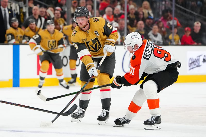 Jan 19, 2026; Las Vegas, Nevada, USA; Philadelphia Flyers right wing Carl Grundstrom (91) tips the puck away from Vegas Golden Knights center Jack Eichel (9) during the third period at T-Mobile Arena. Mandatory Credit: Stephen R. Sylvanie-Imagn Images