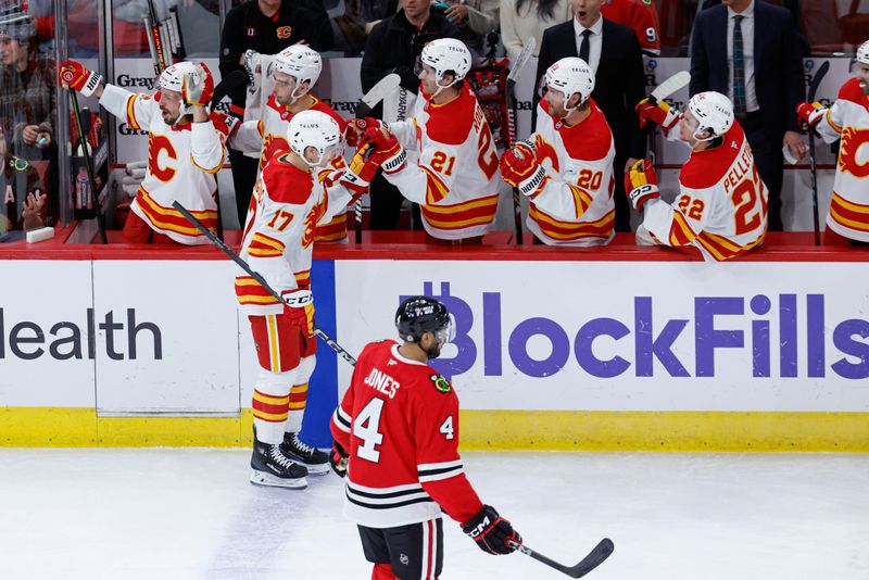 Jan 13, 2025; Chicago, Illinois, USA; Calgary Flames center Yegor Sharangovich (17) celebrates with  teammates after scoring a goal against the Chicago Blackhawks during the second period at United Center. Mandatory Credit: Kamil Krzaczynski-Imagn Images