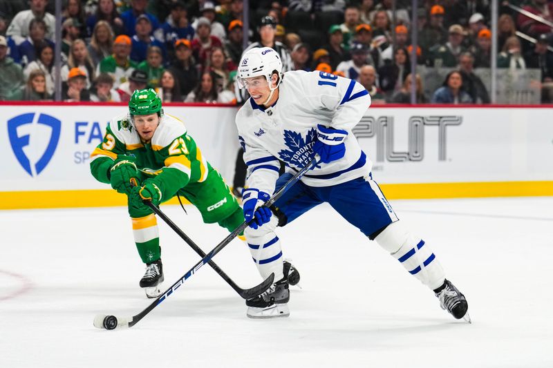 Nov 3, 2024; Saint Paul, Minnesota, USA; Toronto Maple Leafs right wing Mitch Marner (16) skates past Minnesota Wild center Marco Rossi (23) during the first period at Xcel Energy Center. Mandatory Credit: Brace Hemmelgarn-Imagn Images