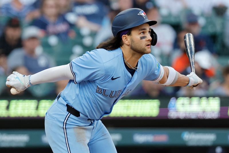 May 23, 2024; Detroit, Michigan, USA;  Toronto Blue Jays shortstop Bo Bichette (11) hits a single in the fourth inning against the Detroit Tigers at Comerica Park. Mandatory Credit: Rick Osentoski-USA TODAY Sports