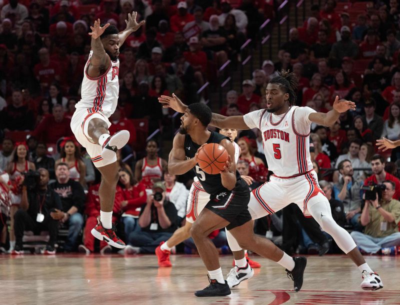 Jan 28, 2023; Houston, Texas, USA; Houston Cougars guard Jamal Shead (1) and Houston Cougars forward Ja'Vier Francis (5) defend against Cincinnati Bearcats guard David DeJulius (5) in the first half at Fertitta Center. Mandatory Credit: Thomas Shea-USA TODAY Sports