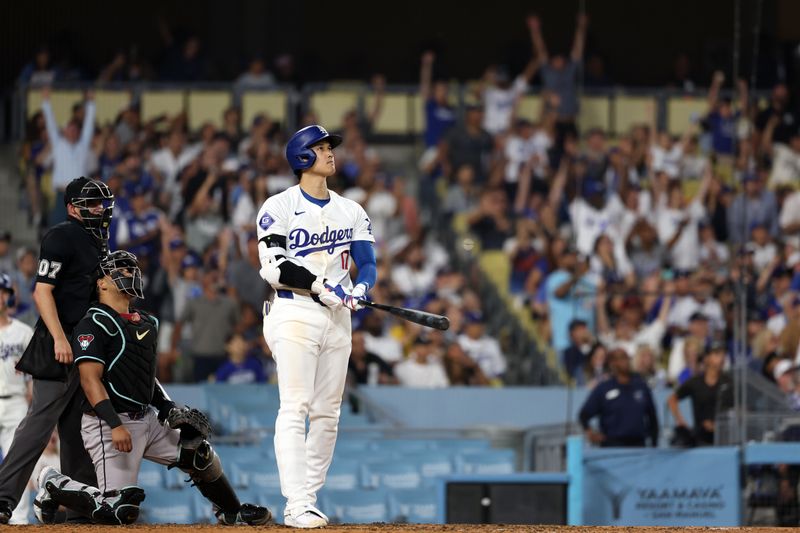 Jul 2, 2024; Los Angeles, California, USA;  Los Angeles Dodgers designated hitter Shohei Ohtani (17) hits a two-run home run during the seventh inning against the Arizona Diamondbacks at Dodger Stadium. Mandatory Credit: Kiyoshi Mio-USA TODAY Sports