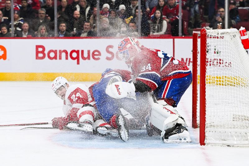 Dec 2, 2023; Montreal, Quebec, CAN; Detroit Red Wings center Klim Kostin (24) collides with Montreal Canadiens goalie Jake Allen (34) during the second period at Bell Centre. Mandatory Credit: David Kirouac-USA TODAY Sports