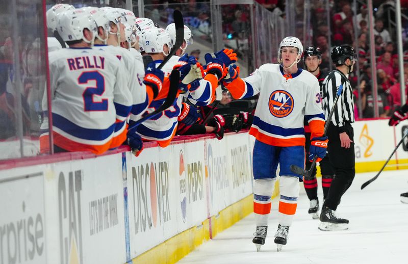 Apr 20, 2024; Raleigh, North Carolina, USA; New York Islanders center Kyle MacLean (32) celebrates his goal against the Carolina Hurricanes during the first period in game one of the first round of the 2024 Stanley Cup Playoffs at PNC Arena. Mandatory Credit: James Guillory-USA TODAY Sports