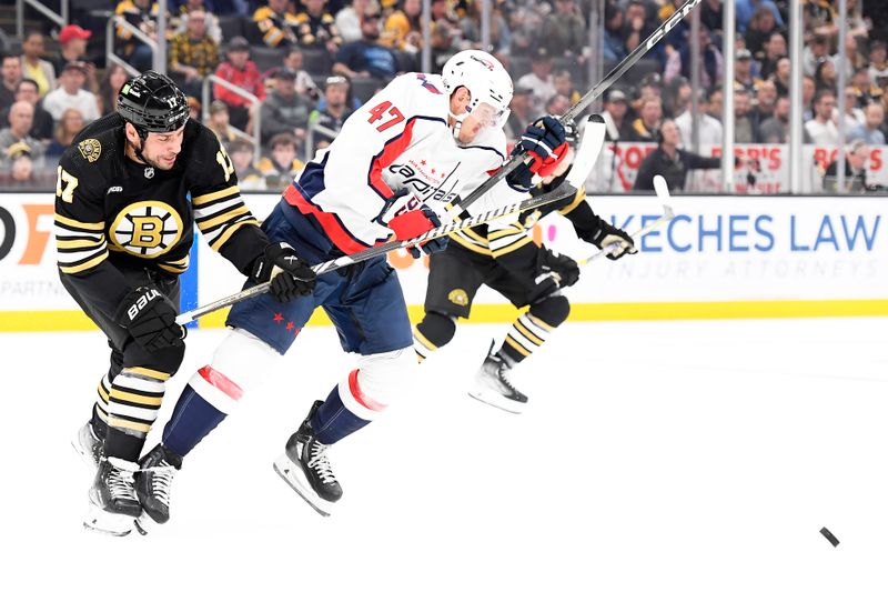 Oct 3, 2023; Boston, Massachusetts, USA;  Boston Bruins left wing Milan Lucic (17) battles for the puck with Washington Capitals left wing Beck Malenstyn (47) during the first period at TD Garden. Mandatory Credit: Bob DeChiara-USA TODAY Sports