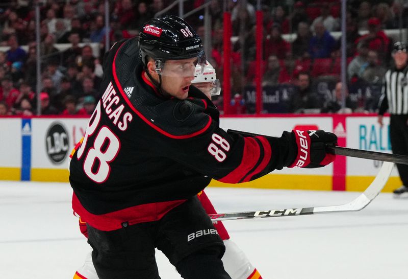 Mar 10, 2024; Raleigh, North Carolina, USA;  Carolina Hurricanes center Martin Necas (88) takes a shot against the Calgary Flames during the first period at PNC Arena. Mandatory Credit: James Guillory-USA TODAY Sports