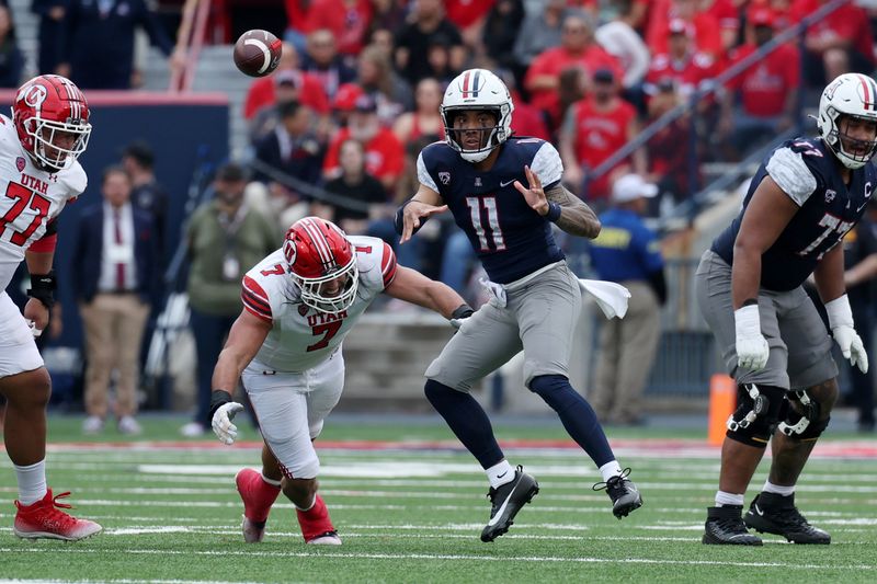 Nov 18, 2023; Tucson, Arizona, USA; Arizona Wildcats quarterback Noah Fifita (11) throws a pass against Utah Utes defensive end Van Fillinger (7) during the second half at Arizona Stadium. Mandatory Credit: Zachary BonDurant-USA TODAY Sports