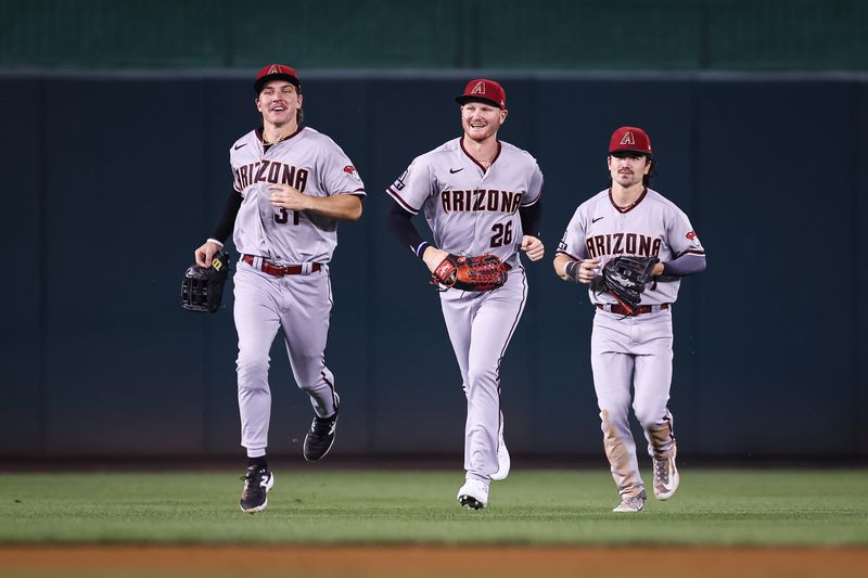 Jun 7, 2023; Washington, District of Columbia, USA; Arizona Diamondbacks left fielder Corbin Carroll (7), center fielder Jake McCarthy (31), and right fielder Pavin Smith (26) celebrate after the game against the Washington Nationals at Nationals Park. Mandatory Credit: Scott Taetsch-USA TODAY Sports