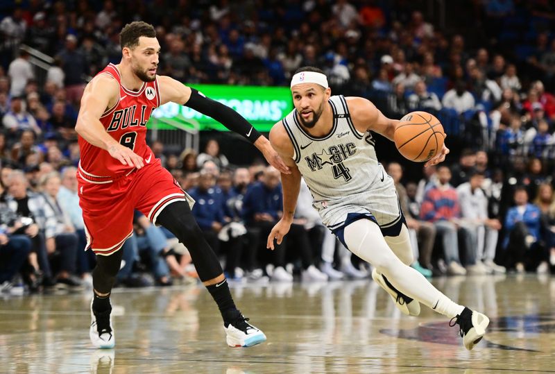 ORLANDO, FLORIDA - NOVEMBER 27: Jalen Suggs #4 of the Orlando Magic drives to the basket against Zach LaVine #8 of the Chicago Bulls in the first half of a game at Kia Center on November 27, 2024 in Orlando, Florida. NOTE TO USER: User expressly acknowledges and agrees that, by downloading and or using this photograph, User is consenting to the terms and conditions of the Getty Images License Agreement. (Photo by Julio Aguilar/Getty Images)