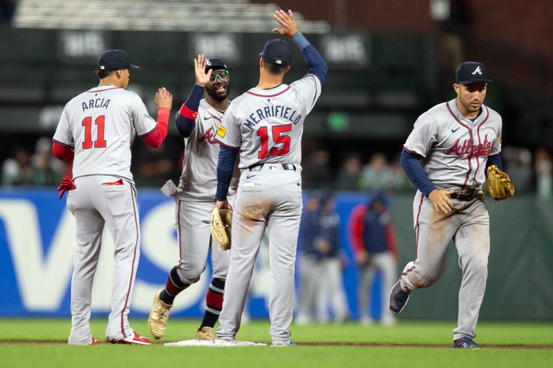 Aug 14, 2024; San Francisco, California, USA; Atlanta Braves center fielder Michael Harris II (second from left) and his teammates celebrate their victory over the San Francisco Giants at Oracle Park. Mandatory Credit: D. Ross Cameron-USA TODAY Sports