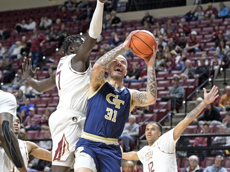 Jan 18, 2025; Tallahassee, Florida, USA;  Georgia Tech Yellowjackets forward Duncan Powell (31) goes up for a shot against Florida State Seminoles forward Jerry Deng (7) during the first half at Donald L. Tucker Center. Mandatory Credit: Robert Myers-Imagn Images