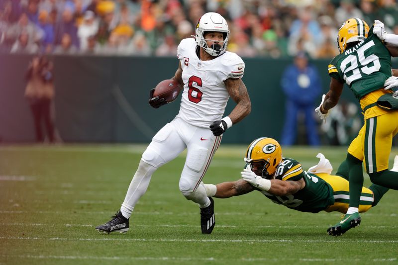 Arizona Cardinals running back James Conner rushes during the first half of an NFL football game against the Green Bay Packers, Sunday, Oct. 13, 2024, in Green Bay. (AP Photo/Matt Ludtke)